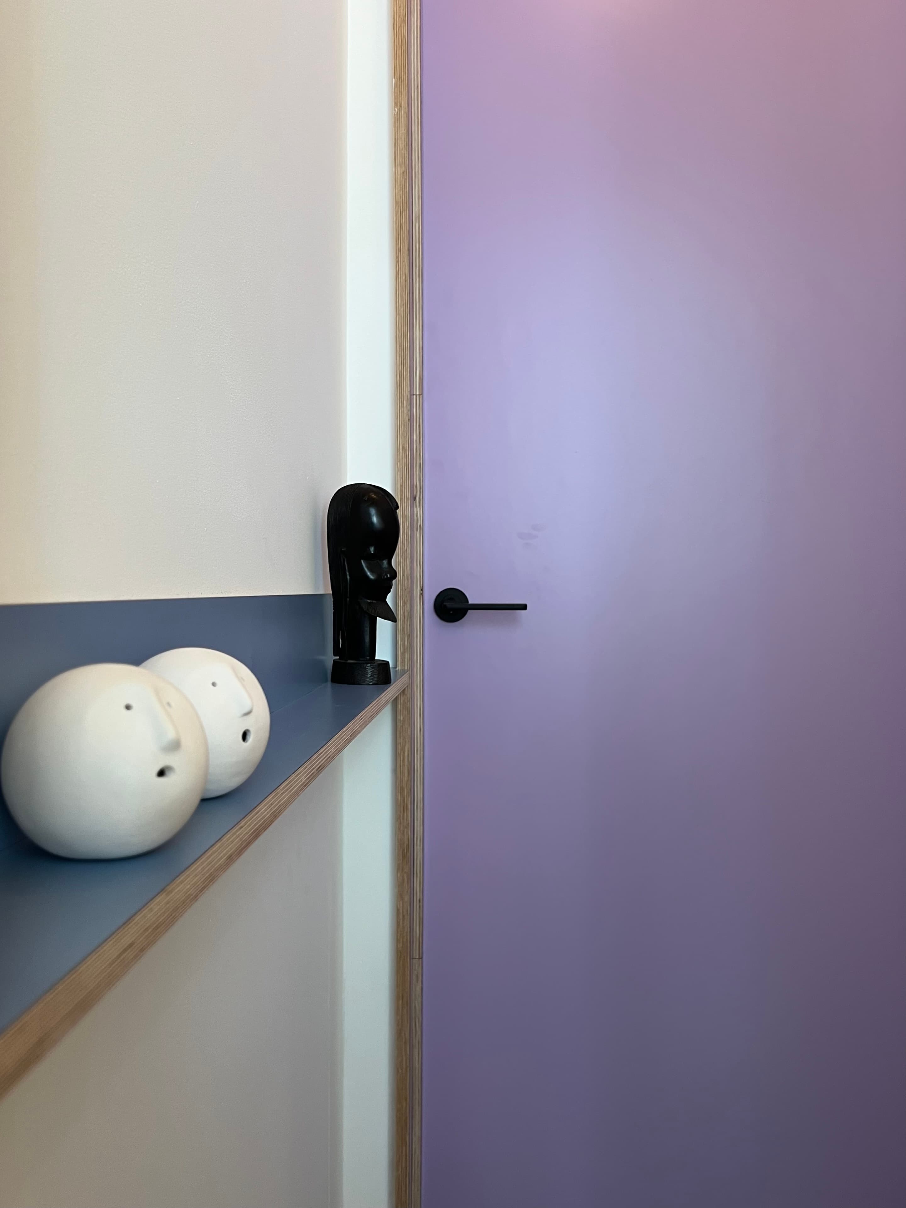 Purple door and shelf detail with black hardware
